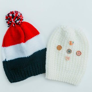 Choose from a yellow patterned beanie with button adornments or a colourful red, white and blue striped beanie with a pompom