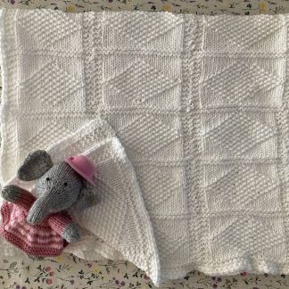 Stunning hand knitted white baby blanket in a diamond pattern, wonderfully soft to the touch