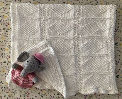 Stunning hand knitted white baby blanket in a diamond pattern, wonderfully soft to the touch