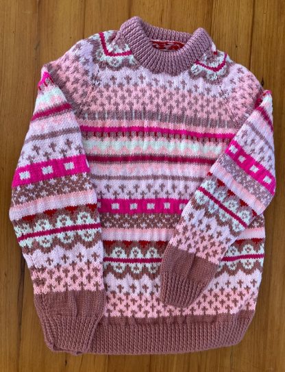 Hand knitted Fair Isle jumper in shades of pink, for very cold days. Round neck Long sleeves Ribbing around neckline, cuffs and hem 100% Acrylic yarn Completed garment measurements: Chest all around: 84cm Length, shoulder to hem ribbing: 59cm Sleeve seam length: 33cm