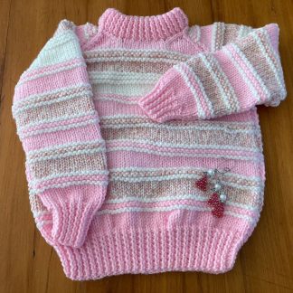 Hand knitted chunky jumper in pink and white Round neck Long sleeves Ribbing around neckline, cuffs and hem 100% Acrylic yarn Completed garment measurements: Chest all around: 78cm Length, shoulder to hem ribbing: 46cm Sleeve seam length: 32cm