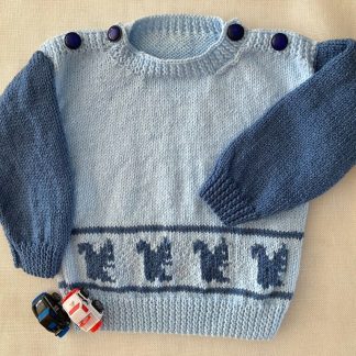 Hand knitted jumper in blue yarn crafted in delightful dark blue squirrels marching across Round neck Buttons on shoulder both shoulders Long sleeves Ribbing around neckline, cuffs and hem 100% Acrylic yarn Completed garment measurements: Chest all around: 62cm Length, shoulder to hem ribbing: 33cm Sleeve seam length: 23cm