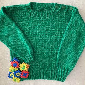 Hand knitted dark green jumper with a distinctive pattern Round neck Buttons on one shoulder