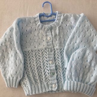 Exquisite lacy cardigan hand knitted in softest baby yarn in pale blue with matching beanie and with 6 whimsical alternating blue and white little duck buttons