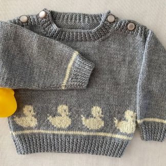 Hand knitted jumper in grey yarn with a row of ducklings featured front and back Buttons on both shoulders