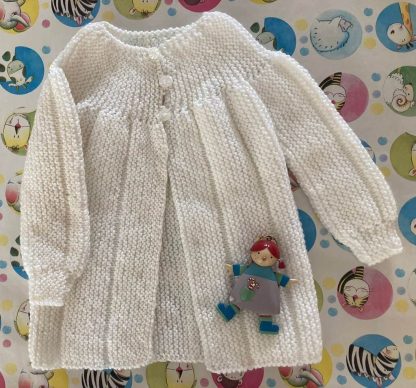 Baby’s jacket hand knitted in softest yarn in white with a yoke in garter stitch 3 pretty flower buttons in front