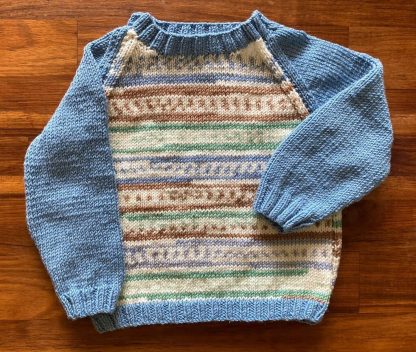 Hand knitted Fair Isle jumper in blue, green and a soft brown Round neck Long sleeves Ribbing around neckline, cuffs and hem Knitted in the softest acrylic yarn that feels like Cashmere