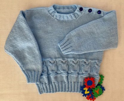 Hand knitted jumper in blue yarn crafted in an adorable owl motif Round neck 3 Buttons on one shoulder Long sleeves Ribbing around neckline, cuffs and hem