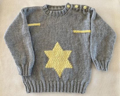 Hand knitted grey jumper with a yellow star knitted motive in front Round neck Yellow buttons on one shoulder Long sleeves Ribbing around neckline, cuffs and hem