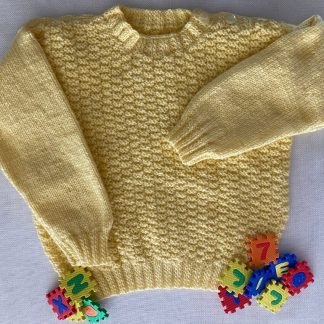 Hand knitted yellow jumper with a distinctive pattern Round neck Buttons on one shoulder Long sleeves Ribbing around neckline, cuffs and hem