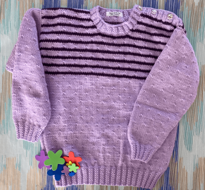 Mauve coloured jumper with purple stripes and a seed pattern