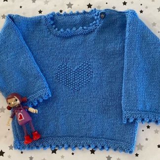 Hand knitted blue jumper with a heart motif Round neck Cute button on one shoulder Long sleeves Picot edging around neckline, cuffs and hem 100% Acrylic yarn