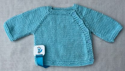 Beautiful hand knitted blue jacket with 6 pretty flower buttons down the side of the jacket. Square neck Long Sleeves Garter stitch around neckline, cuffs and hem. Beautiful soft 100% Acrylic yarn that feels like Cashmere