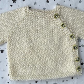 Beautiful hand knitted cream jacket with 6 delightful Teddy Bear buttons down the side of the jacket. Square neck Long Sleeves Garter stitch around neckline, cuffs and hem. Lovely soft 100% Acrylic yarn which feels like Cashmere